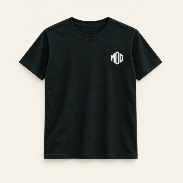 Concept ink T-shirt, front view, with a small left-chest angular MOD monogram.