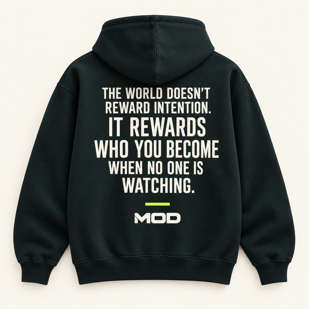 Concept ink hoodie, back view, with “The World Doesn’t Reward Intention. It Rewards Who You Become When No One Is Watching.” lettering and MOD below.